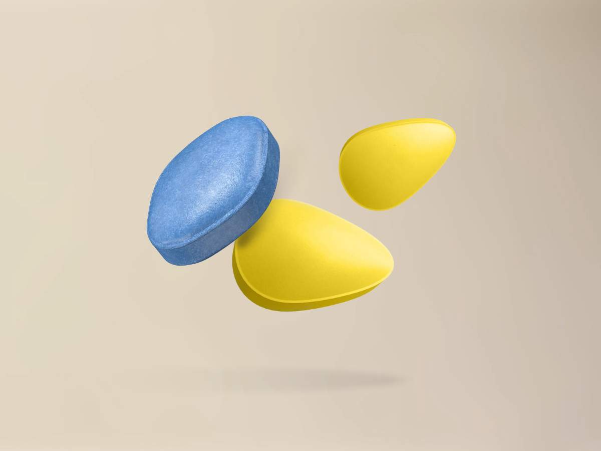 Floating blue and yellow ED pills representing Sildenafil and Tadalafil. Discover how ED medications work for Filipino men at andyou.ph.